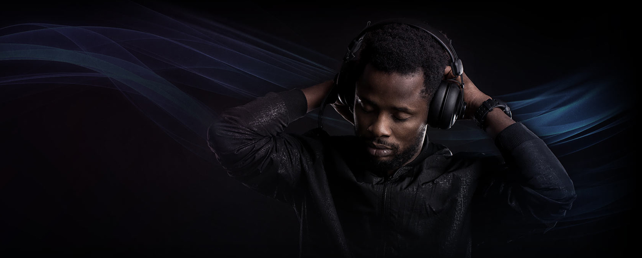 A man has a headset on and gets immersed in the music.